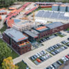 Luftaufnahme des modernen Schulte Firmengebäudes mit Solarpanels, Parkplatz und angrenzender Baustelle