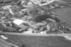 Historische Luftaufnahme der Bauunternehmung Schulte mit Wohnhäusern, Betriebsgebäuden und Baustelle aus den 1970er Jahren